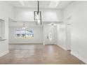 Open-concept living room featuring high ceilings and a stylish decorative ceiling light at 807 Scrub Oak St, South Daytona, FL 32119