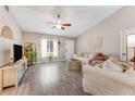 Bright living room showcasing vaulted ceilings, wood-look flooring, and neutral paint at 1719 Anniston Ave, Daytona Beach, FL 32117