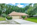 Charming one-story brick home featuring a well-manicured lawn and an attached two-car garage at 2270 Wilmhurst Rd, Deland, FL 32720