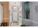 Bright hallway featuring neutral paint colors and decorative nooks at 3160 Bailey Ann Dr, Ormond Beach, FL 32174