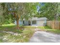 Charming single-story home with a well-kept lawn, attached garage, and inviting entrance at 7686 Sw 81St St, Ocala, FL 34476