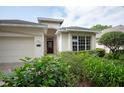 Attractive one-story home with a two-car garage and beautiful front garden at 902 Heron Point Cir, Deland, FL 32724