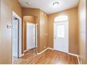 Inviting foyer with gleaming hardwood floors, arched doorway, and natural light streaming through the front door at 902 Heron Point Cir, Deland, FL 32724