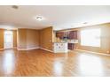 Spacious living room boasting hardwood floors, ample space, and seamless flow into the kitchen area at 902 Heron Point Cir, Deland, FL 32724