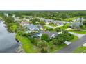 An aerial view of a neighborhood featuring mature landscaping and a lake with various homes at 101 Green Heron Ct, Daytona Beach, FL 32119