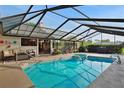 Enjoy a refreshing dip in this screened-in pool with lounging area and peaceful backyard at 101 Green Heron Ct, Daytona Beach, FL 32119