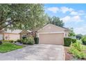 Beautiful single-story home with a two-car garage and meticulously maintained landscaping at 25216 Ironwedge Dr, Sorrento, FL 32776
