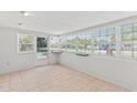 Bright sunroom with neutral tile floors and large windows providing ample natural light at 321 Scotland Dr, Daytona Beach, FL 32117