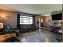 Comfortable living room featuring polished concrete floors and a large window for natural light at 35 Whippoorwill Ln, Ormond Beach, FL 32174