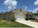Charming single Gathering home with a well-manicured lawn and a two car garage at 551 Shaelyn Pl, Deland, FL 32724
