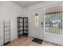 Bright foyer featuring decorative tile flooring and a secure front entrance with an oval window at 1333 E Lombardy Dr, Deltona, FL 32725