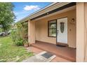 Inviting covered front porch with decorative plant and space for outdoor seating at 1333 E Lombardy Dr, Deltona, FL 32725