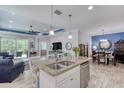 Kitchen island featuring granite countertops, stainless steel appliances, and open floor plan concept at 206 St Somewhere Dr, Daytona Beach, FL 32124