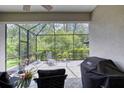 Screened-in lanai featuring patio furniture and outdoor views at 206 St Somewhere Dr, Daytona Beach, FL 32124