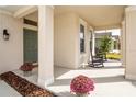 Inviting front porch with rocking chairs and decorative plants, perfect for relaxing and enjoying the outdoors at 2861 Monaghan Dr, Ormond Beach, FL 32174
