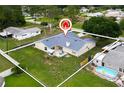 Aerial view of a fenced property with a backyard featuring a patio, fire pit, and an above ground swimming pool at 2910 Yule Tree Dr, Edgewater, FL 32141