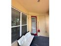 Covered porch with neutral colored sofa and a view of the yard at 3660 Daydream Pl, St Cloud, FL 34772