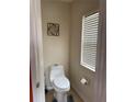 Cozy powder room with a toilet and a window that provides natural light at 3660 Daydream Pl, St Cloud, FL 34772