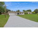 Lovely house with a well-kept lawn, painted white brick, and a convenient attached garage at 999 16Th St, Edgewater, FL 32132