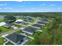 Beautiful aerial view of homes in a community with serene ponds and lush green spaces at 2137 Raglan Cir, Ormond Beach, FL 32174