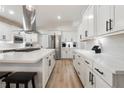 Bright, updated kitchen with white cabinets, stainless steel appliances, and an island with seating at 21375 Nw 150Th Avenue Rd, Micanopy, FL 32667