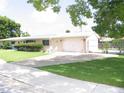 Ranch style home featuring an attached garage, expansive front lawn, and concrete driveway at 39 Benjamin Dr, Ormond Beach, FL 32176