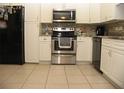 Updated kitchen featuring stainless steel appliances, white cabinets, and a stylish backsplash at 39 Benjamin Dr, Ormond Beach, FL 32176