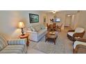 Comfortable living room with a casual dining area, featuring wicker furniture and beach accents at 4155 S Atlantic Ave # 204, New Smyrna Beach, FL 32169