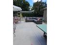 Relaxing backyard featuring patio furniture and green trees at 441 N Kentucky Ave, Deland, FL 32724