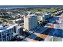 An aerial daytime view of a condo on the beach overlooking the ocean with a pool area between the building and ocean at 89 S Atlantic Ave # 1004, Ormond Beach, FL 32176