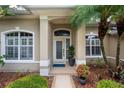 Charming home front door entrance with sidelights, decorative glass and manicured landscaping at 1254 Royal Pointe Ln, Ormond Beach, FL 32174