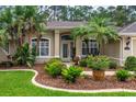 Beautiful home exterior with well-kept landscaping and a welcoming front entrance at 1254 Royal Pointe Ln, Ormond Beach, FL 32174