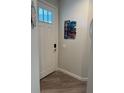 View of the house's front door with a modern lock and nautical-themed decor at 146 Via Madrid Dr, Ormond Beach, FL 32176