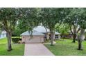 Inviting one-story home featuring a two-car garage and beautiful landscaping enhancing curb appeal at 24 Katrinas Dr, Ormond Beach, FL 32174