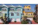 Charming blue and yellow townhomes with garages and balconies offer a coastal living experience at 3000 Ocean Shore Blvd # 18, Ormond Beach, FL 32176