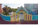 Pool area with colorful gate and fence leading to the community pool at 3000 Ocean Shore Blvd # 18, Ormond Beach, FL 32176