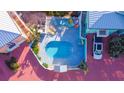 Aerial view of the neighborhood pool surrounded by colorful chairs and a lounge area at 3000 Ocean Shore Blvd # 18, Ormond Beach, FL 32176