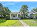 Inviting single-story home featuring a covered porch, manicured landscaping, and a well-maintained lawn at 3132 Connemara Dr, Ormond Beach, FL 32174