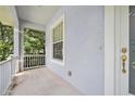 Covered front porch offers a shaded entrance with a view of the landscaped yard at 3132 Connemara Dr, Ormond Beach, FL 32174