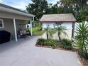 Backyard featuring a shed, carport, and well-manicured landscaping at 1218 Daytona Ave, Daytona Beach, FL 32117