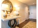 Inviting entryway featuring stylish console table, decor, and a textured rug on beautiful hardwood floors at 231 Riverside Dr # 1602, Holly Hill, FL 32117