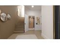 Elegant home entryway with wood-paneled wall, stairway, and elevator access for easy accessibility at 2360 Ocean Shore Blvd # 18, Ormond Beach, FL 32176