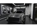 Luxury garage featuring a sleek gray Bentley, vintage car prints, and modern lighting at 2360 Ocean Shore Blvd # 8, Ormond Beach, FL 32176