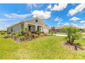 Inviting home featuring a well-maintained lawn, decorative landscaping, and a cozy front porch at 2836 Monaghan Dr, Ormond Beach, FL 32174