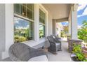 Inviting front porch with comfortable seating, perfect for enjoying the neighborhood views and relaxing outdoors at 2836 Monaghan Dr, Ormond Beach, FL 32174