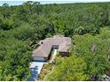 Aerial view of a brick single story home surrounded by mature trees at 1108 Northside Dr, Ormond Beach, FL 32174
