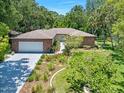 Beautiful single story brick home featuring a large driveway and manicured lawn at 1108 Northside Dr, Ormond Beach, FL 32174