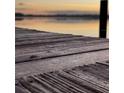 Closeup of an old wooden dock with a blurry view of the water at sunset at 1162 Carmel Cir # 100, Casselberry, FL 32707
