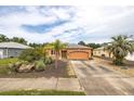 Charming one-story home featuring a well-kept yard, driveway, and neutral exterior paint scheme at 209 Falcon Ave, Edgewater, FL 32141