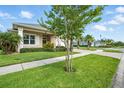 A well-manicured lawn and mature trees complement the exterior of this charming single-story home at 3048 Borassus Dr, New Smyrna Beach, FL 32168